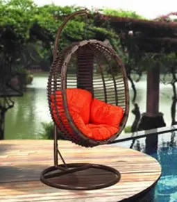 Rattan hanging swing seat with orange cushion
